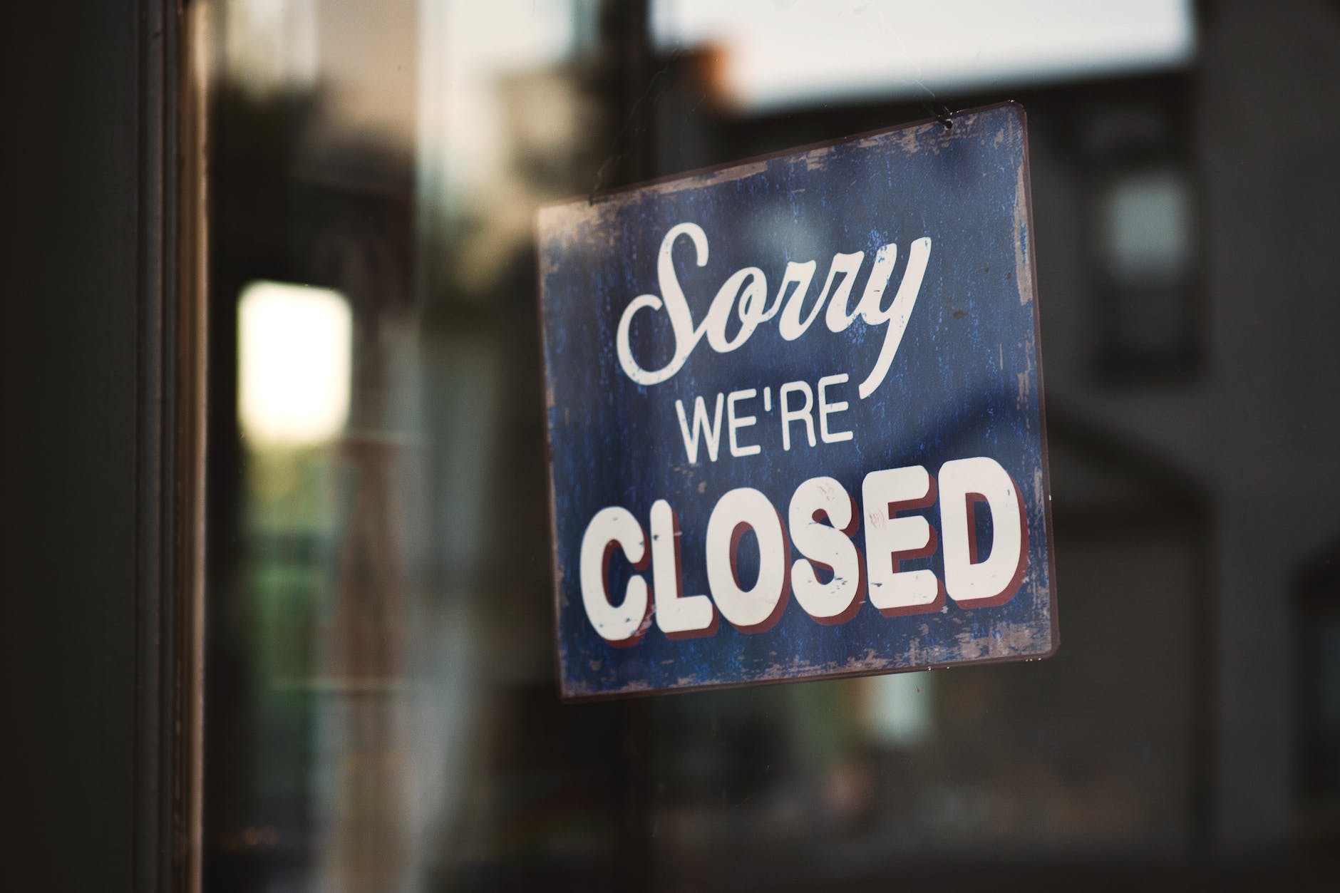 blue and white sorry we re closed wooden signage