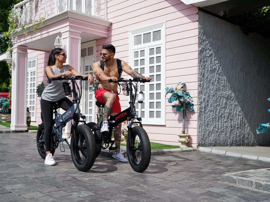 man and woman riding electric bikes