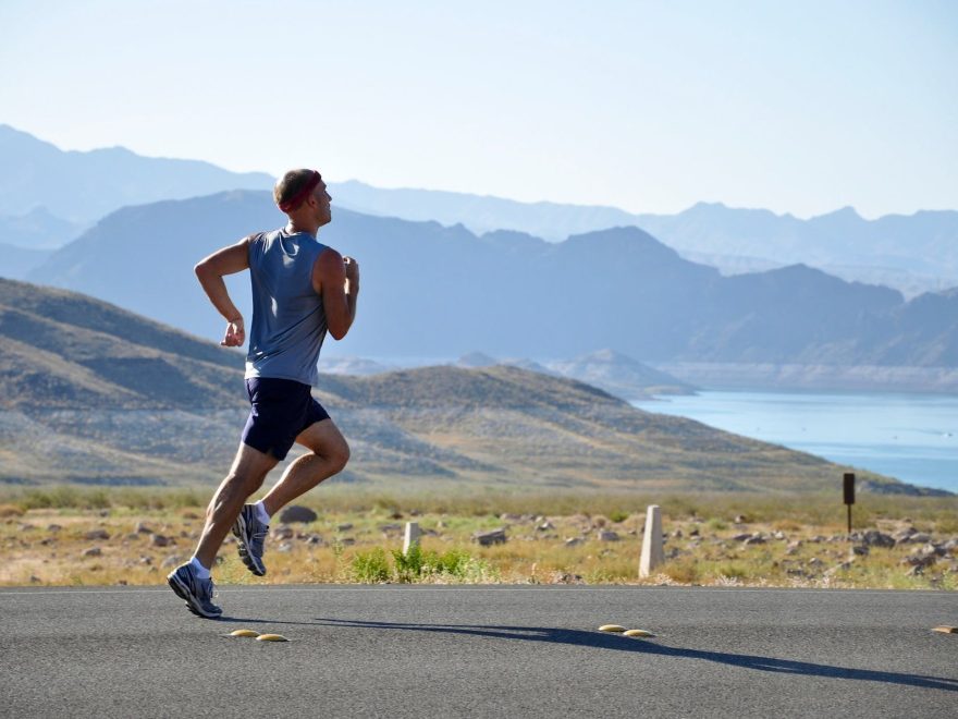 man running on side of road