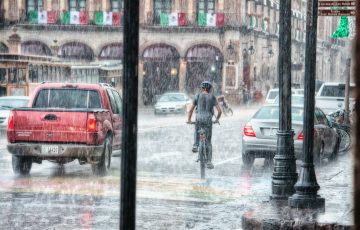 person riding a bicycle during rainy day