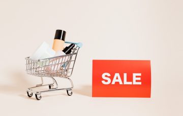 merchandise in a shopping cart on white background