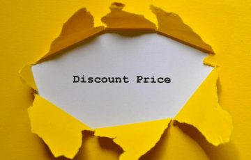 torn yellow paper revealing discount price