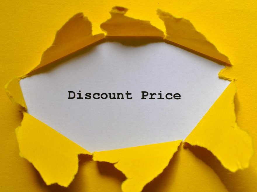 torn yellow paper revealing discount price
