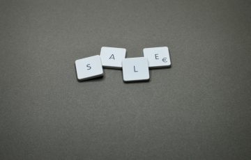 four white sale boards